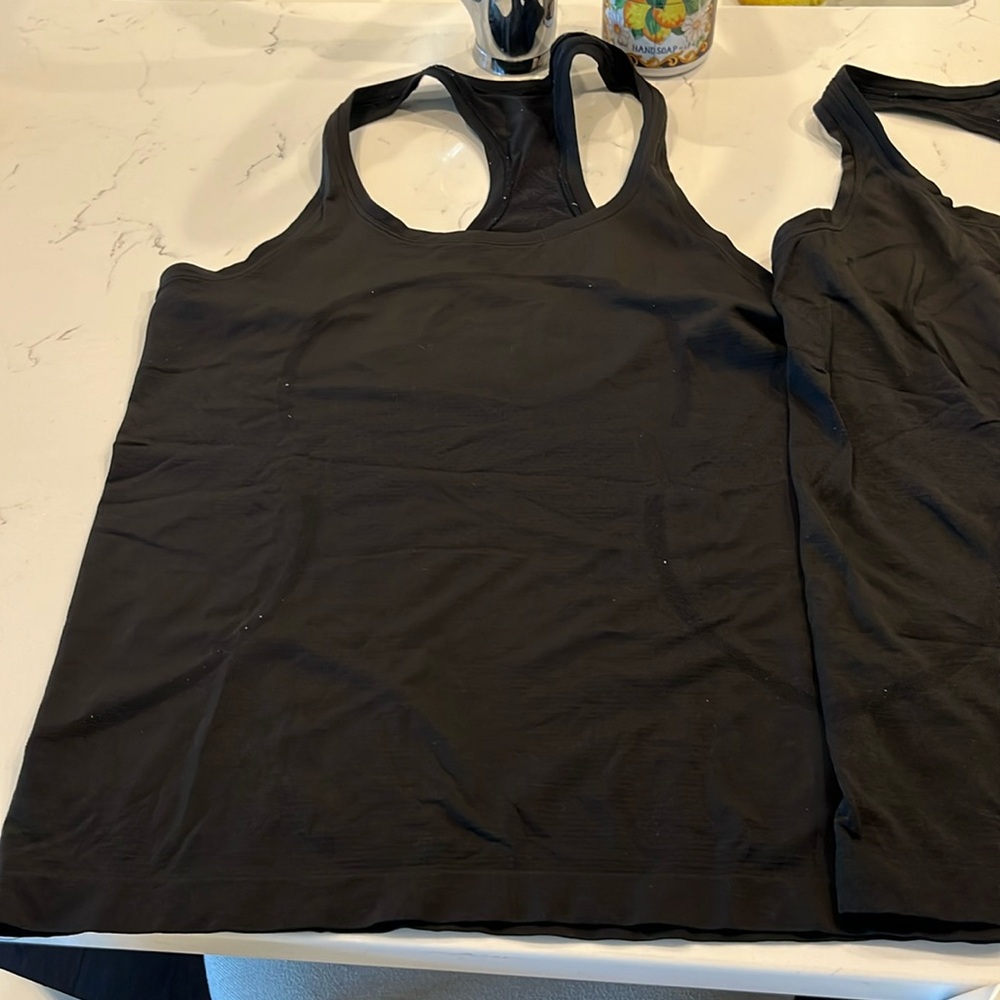 Two Lululemon black tanks - no tags.  I think size 10 but the tags are gone.
